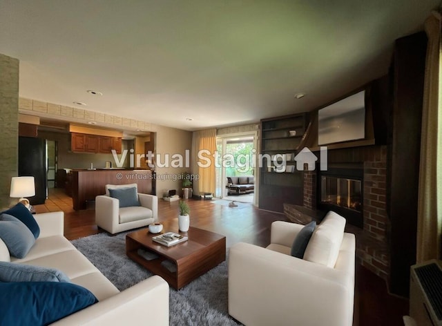 living room with dark hardwood / wood-style floors and a brick fireplace