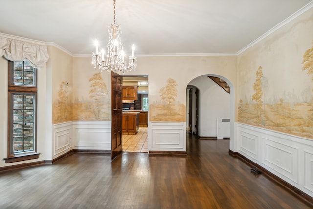 unfurnished dining area with dark hardwood / wood-style floors, ornamental molding, radiator, and an inviting chandelier