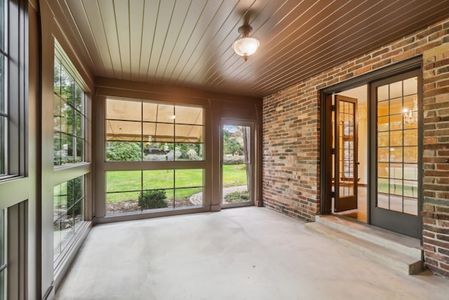 unfurnished sunroom featuring wood ceiling