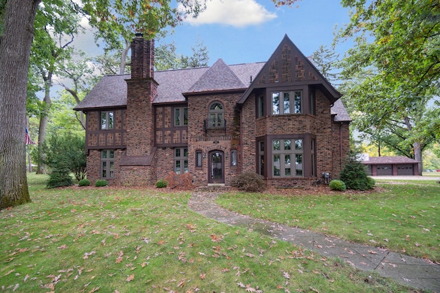 tudor-style house with a front lawn