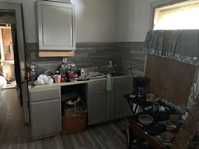 124 W Flint Park Blvd, Flint, MI 48505 - kitchen with wood finished floors, white cabinets, light countertops, and a wainscoted wall