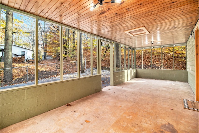 unfurnished sunroom with wood ceiling