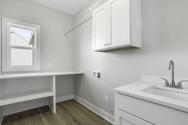 clothes washing area featuring dark wood-type flooring, sink, cabinets, and hookup for a washing machine