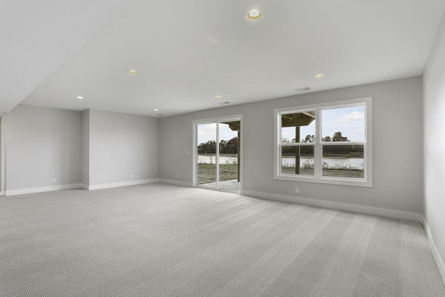 empty room with light carpet and a water view