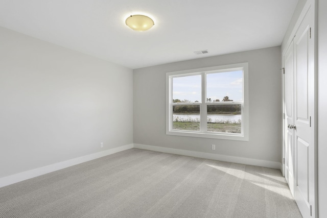 empty room featuring light colored carpet