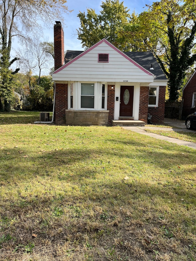 view of front of property featuring central AC and a front lawn