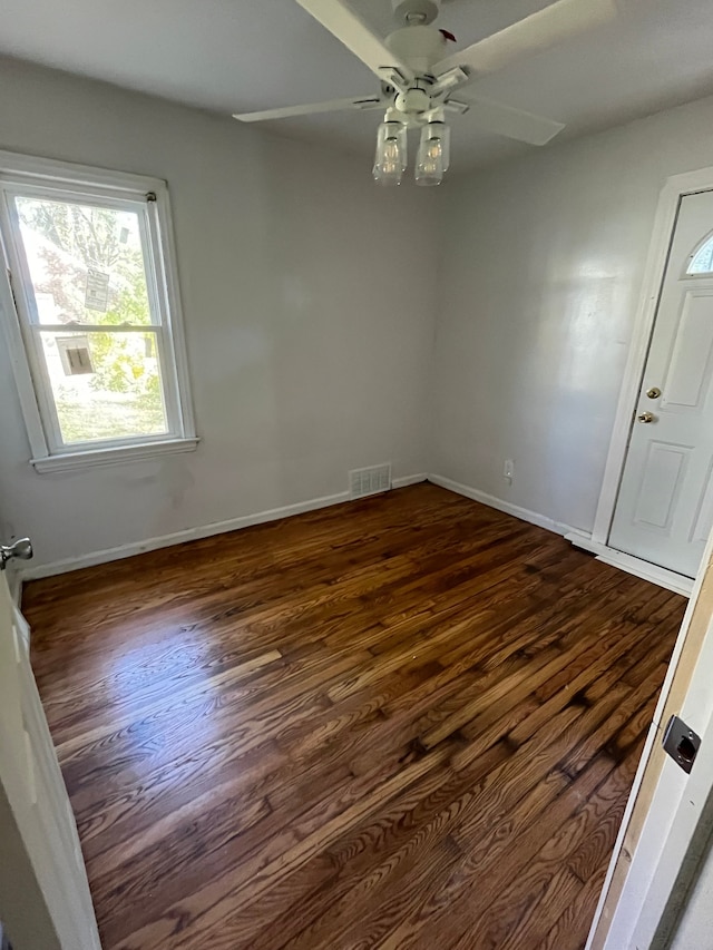 unfurnished room featuring ceiling fan and dark wood-type flooring