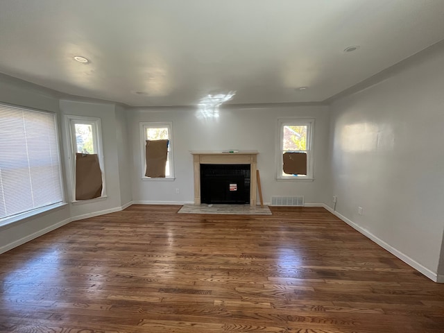 unfurnished living room with dark hardwood / wood-style floors