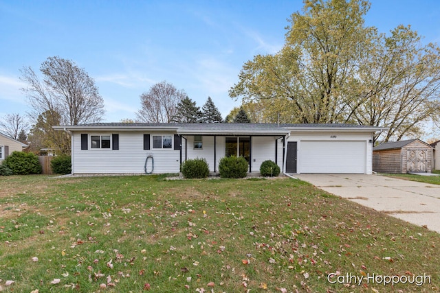 ranch-style home featuring a front yard, a garage, and a storage shed