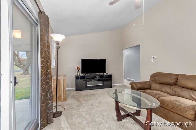 living room featuring carpet flooring, ceiling fan, and lofted ceiling