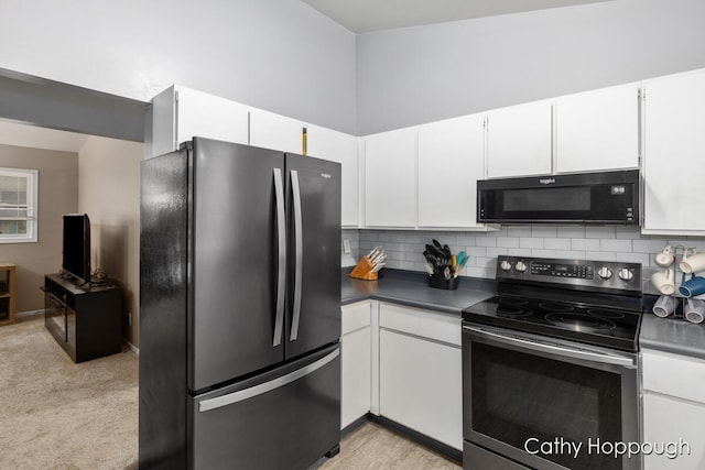 kitchen featuring white cabinets, light carpet, backsplash, and stainless steel appliances