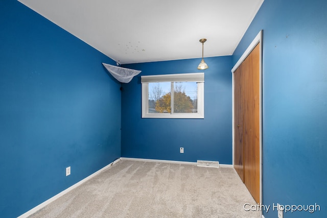 unfurnished bedroom featuring carpet and a closet