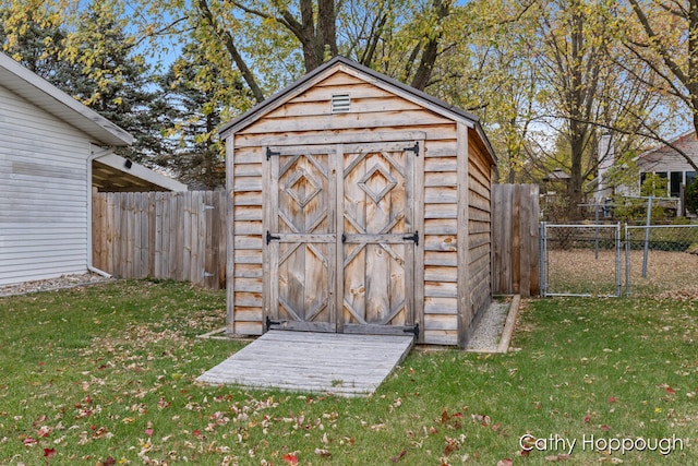 view of outbuilding featuring a lawn