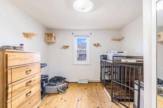 interior space with hardwood / wood-style floors and a textured ceiling