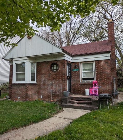 13614 Montrose St, Detroit, MI 48227 - bungalow-style home with brick siding, a front yard, and a chimney