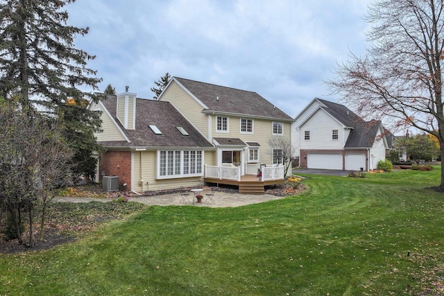 back of property with a yard, a deck, and central air condition unit