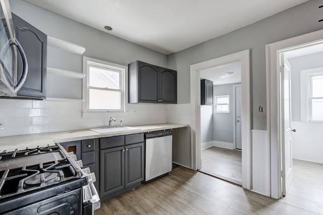 kitchen featuring gray cabinets, plenty of natural light, stainless steel appliances, and sink