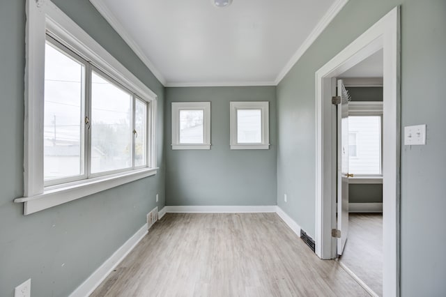 unfurnished room featuring light hardwood / wood-style floors and ornamental molding