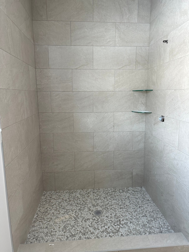 bathroom with tiled shower