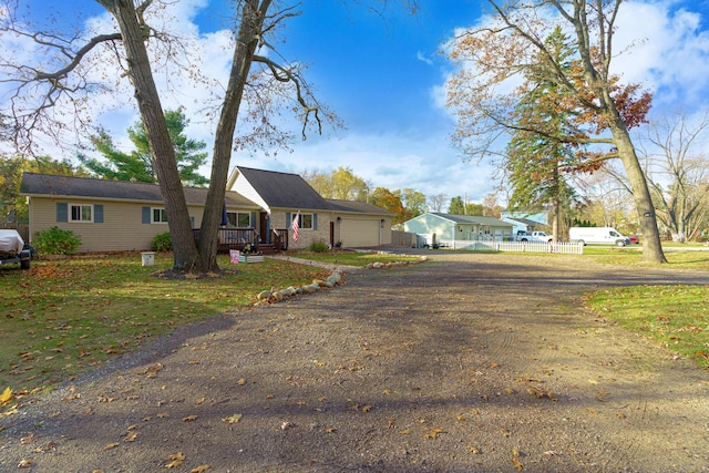 view of front facade with a front lawn, covered porch, and a garage