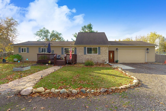 single story home with a front yard, a garage, and a wooden deck