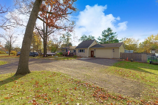 view of front of home with a garage and a front lawn