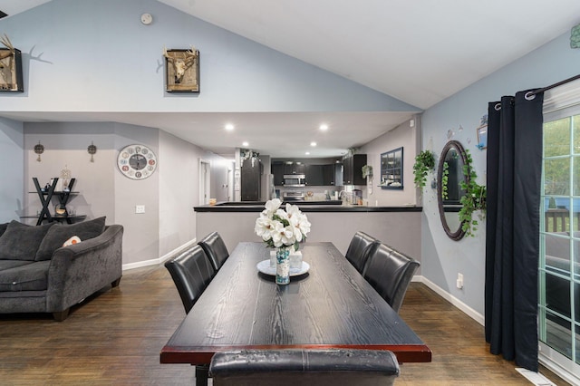 dining room with dark hardwood / wood-style floors and high vaulted ceiling