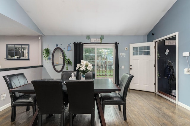 dining area with hardwood / wood-style flooring and lofted ceiling