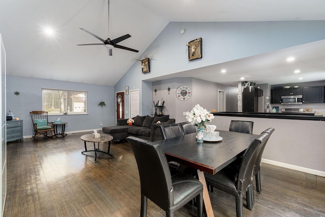 dining area with high vaulted ceiling, ceiling fan, and dark wood-type flooring