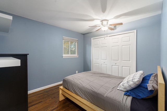 bedroom featuring dark hardwood / wood-style flooring, a closet, and ceiling fan