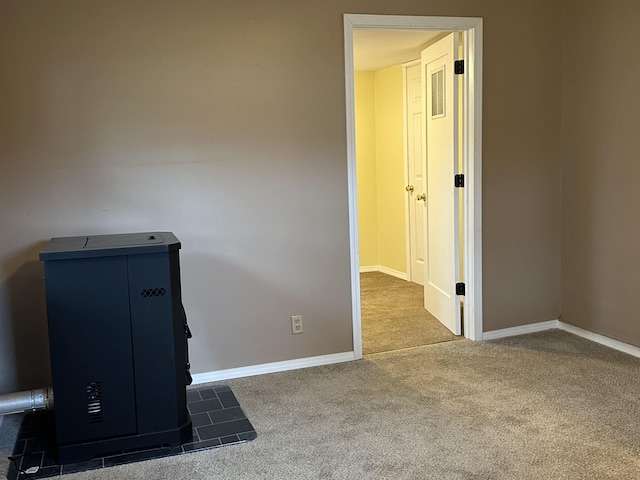 4465 Filter Rd, Harrison, MI 48625 - spare room featuring carpet flooring, a wood stove, and baseboards