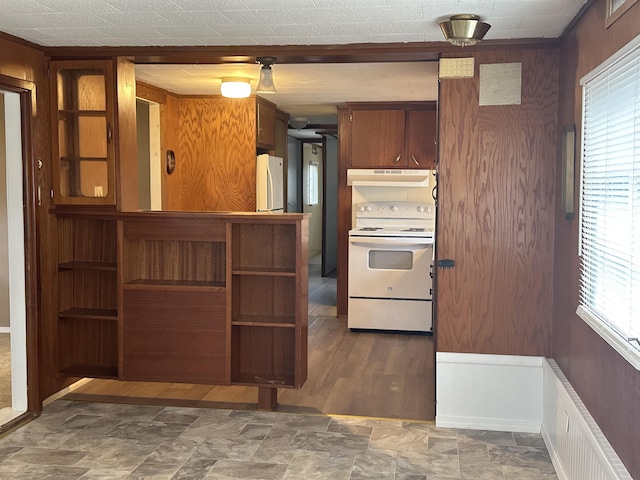 4465 Filter Rd, Harrison, MI 48625 - kitchen featuring white appliances, under cabinet range hood, brown cabinets, and stone finish flooring