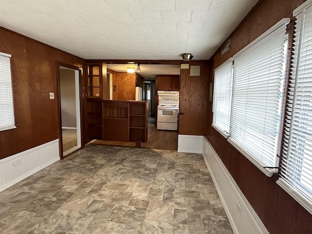 4465 Filter Rd, Harrison, MI 48625 - kitchen featuring white range with electric stovetop, plenty of natural light, wooden walls, and baseboards