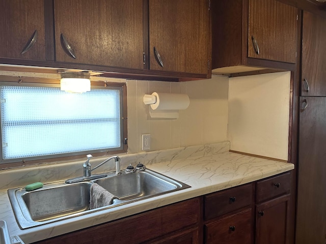 4465 Filter Rd, Harrison, MI 48625 - kitchen featuring a sink, light countertops, and dark brown cabinetry