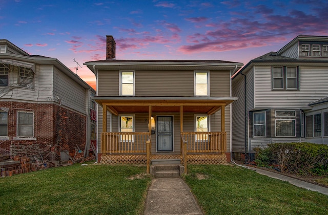 view of front of home with a lawn and covered porch