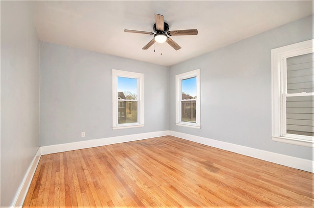 spare room with ceiling fan, baseboards, and wood finished floors