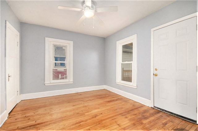 foyer entrance featuring light wood-type flooring, ceiling fan, and baseboards