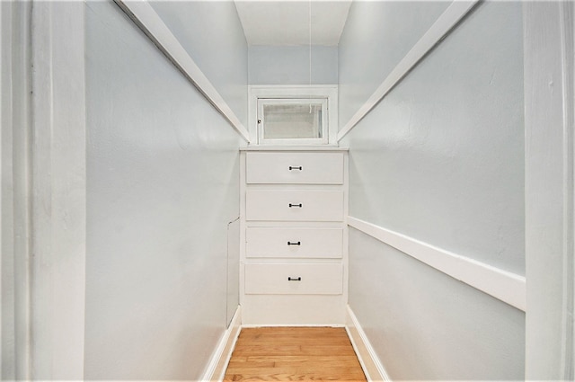 spacious closet with hardwood / wood-style floors