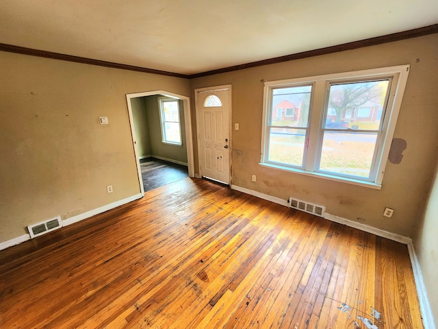 entryway with hardwood / wood-style floors and ornamental molding