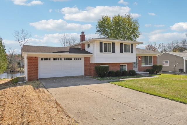 tri-level home featuring a garage and a front lawn