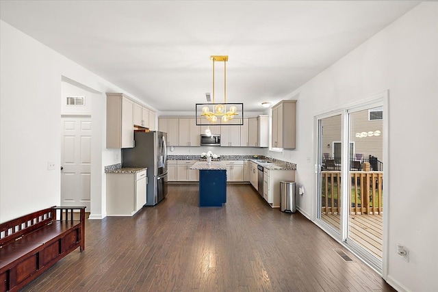 kitchen with a center island, decorative light fixtures, stainless steel appliances, and dark wood-type flooring