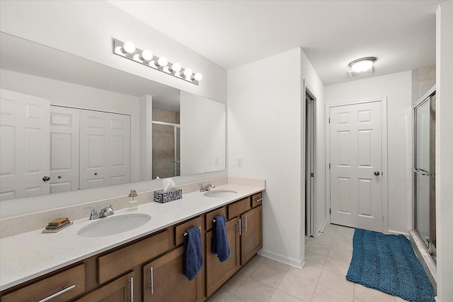 bathroom featuring tile patterned flooring, vanity, and an enclosed shower