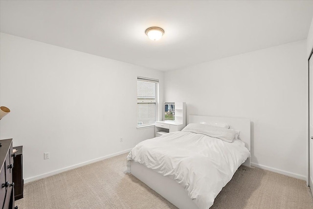 bedroom featuring light colored carpet