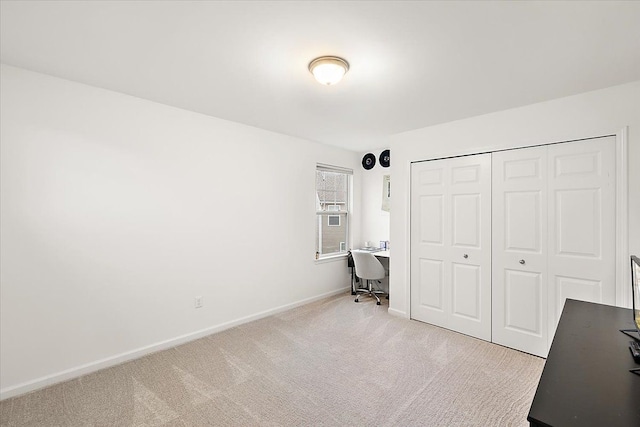 unfurnished bedroom with light carpet and a closet