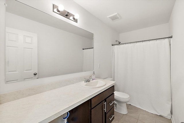 bathroom featuring tile patterned flooring, vanity, and toilet