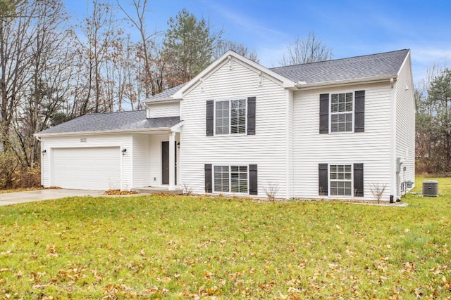 tri-level home featuring central air condition unit, a front lawn, and a garage