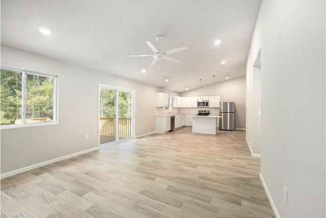 unfurnished living room with ceiling fan, light hardwood / wood-style floors, and lofted ceiling