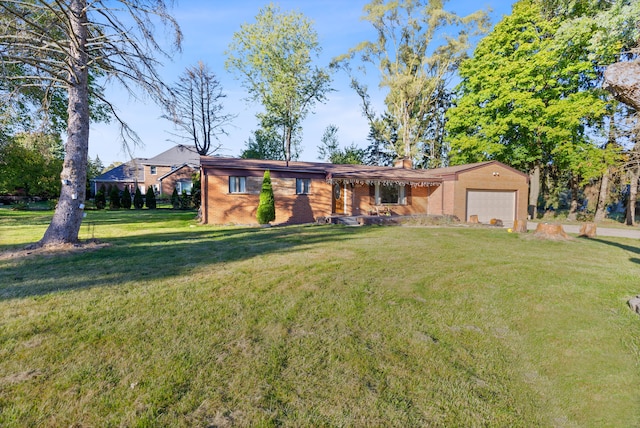 ranch-style house featuring a front lawn and a garage