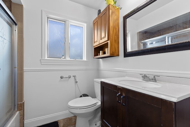 full bathroom featuring shower / bath combination with glass door, vanity, and toilet