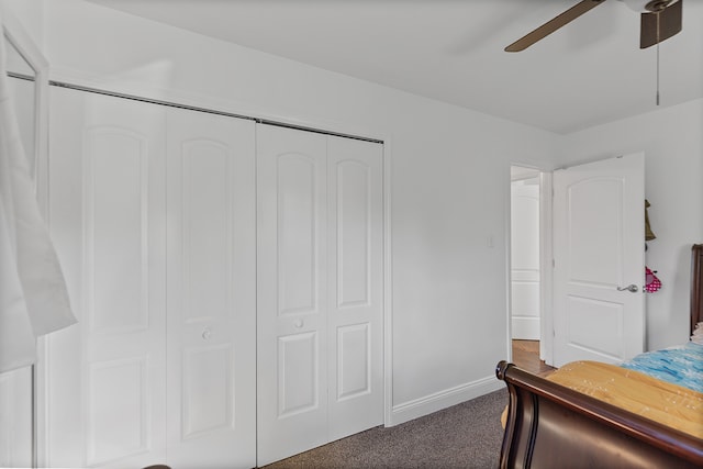 carpeted bedroom featuring ceiling fan and a closet